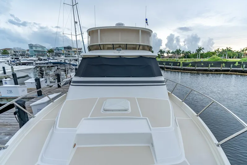 Mountain Mermaid Yacht Photos Pics 2004 Offshore Yachts 54 Pilothouse docked in a marina, surrounded by other boats.