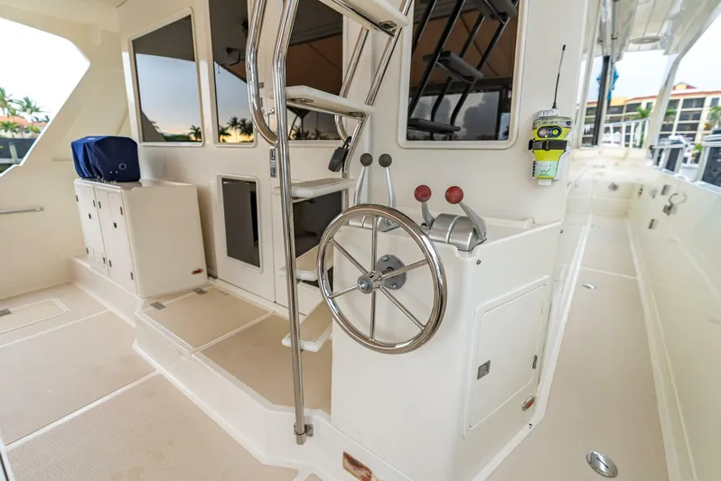Mountain Mermaid Yacht Photos Pics 2004 Offshore Yachts 54 Pilothouse deck with steering wheel and controls.