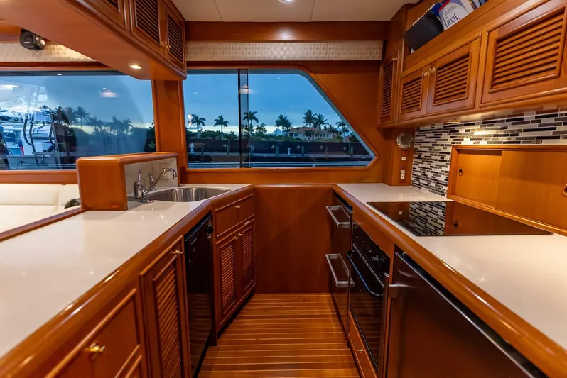 Mountain Mermaid Yacht Photos Pics Luxurious kitchen interior of 2004 Offshore Yachts 54 Pilothouse with modern appliances and wood finish.