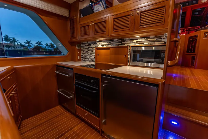 Mountain Mermaid Yacht Photos Pics Luxurious galley in 2004 Offshore Yachts 54 Pilothouse with modern appliances and wood finish.