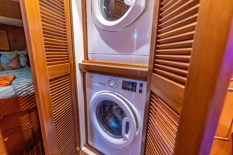 Mountain Mermaid Yacht Photos Pics Stacked washer and dryer in 2004 Offshore Yachts 54 Pilothouse, wooden louvered doors.