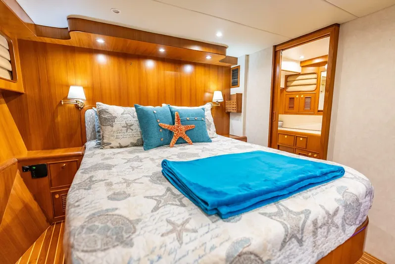Mountain Mermaid Yacht Photos Pics Luxurious cabin interior of 2004 Offshore Yachts 54 Pilothouse with nautical-themed bedding.