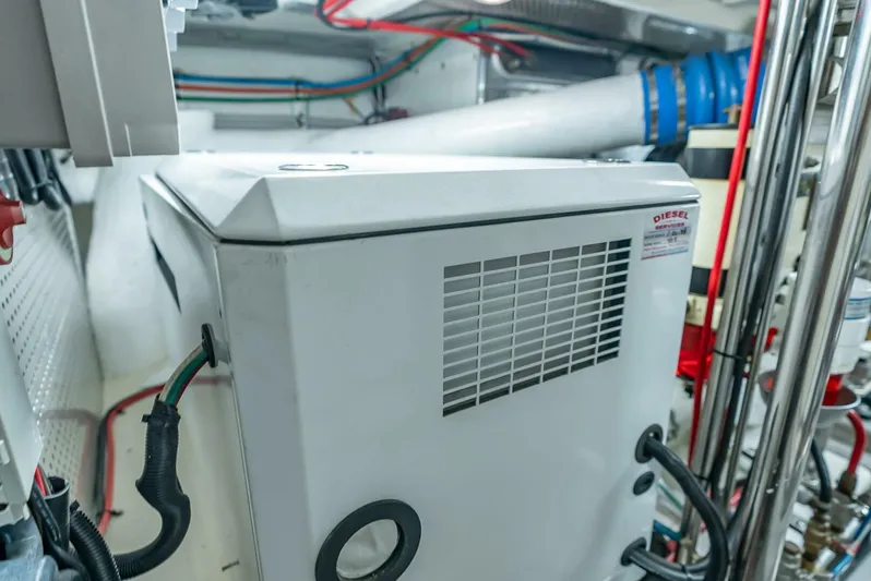 Mountain Mermaid Yacht Photos Pics Engine room of 2004 Offshore Yachts 54 Pilothouse with diesel generator and wiring.