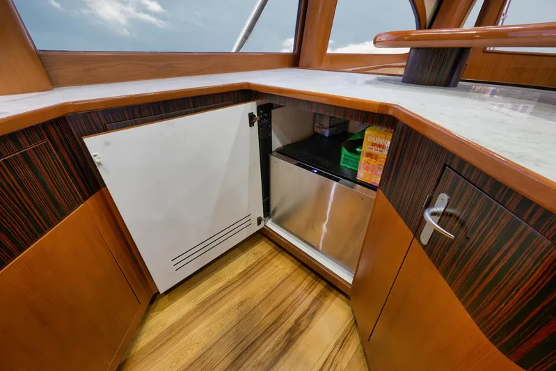 Raise Em Up Yacht Photos Pics Interior view of 2007 Sunny Briggs Custom Carolina Sportfish with open cabinet and mini fridge.