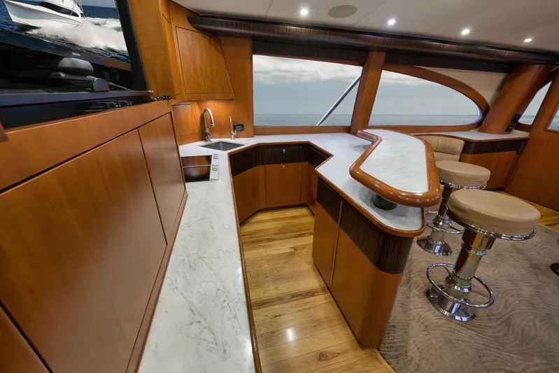 Raise Em Up Yacht Photos Pics Luxurious interior of 2007 Sunny Briggs Custom Carolina Sportfish yacht with elegant wood and marble finishes.