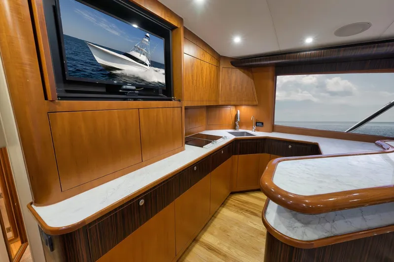 Raise Em Up Yacht Photos Pics Luxurious interior of 2007 Sunny Briggs Custom Carolina Sportfish yacht with wood cabinetry and marble countertops.