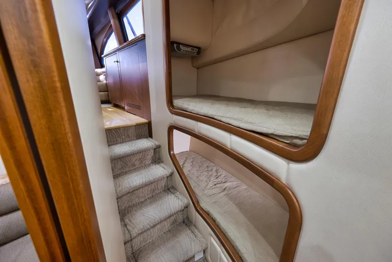 Raise Em Up Yacht Photos Pics Interior of 2007 Sunny Briggs Custom Carolina Sportfish with cozy bunk beds and wooden accents.