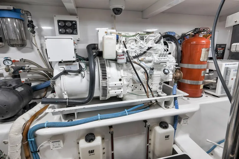 Raise Em Up Yacht Photos Pics Engine room of 2007 Sunny Briggs Custom Carolina Sportfish with generator and fire extinguisher.