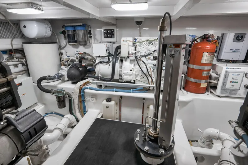 Raise Em Up Yacht Photos Pics Engine room of 2007 Sunny Briggs Custom Carolina Sportfish with equipment and fire extinguisher.