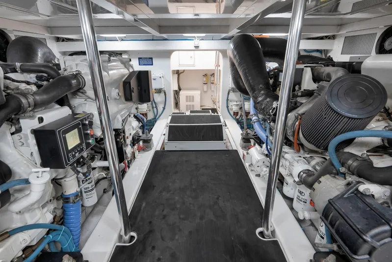 Raise Em Up Yacht Photos Pics Engine room of 2007 Sunny Briggs Custom Carolina Sportfish, showcasing dual engines and equipment.