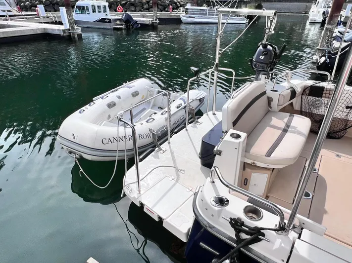 Cannery Row Yacht Photos Pics 2015 Cutwater C-30 Sedan docked with inflatable boat, marina setting.