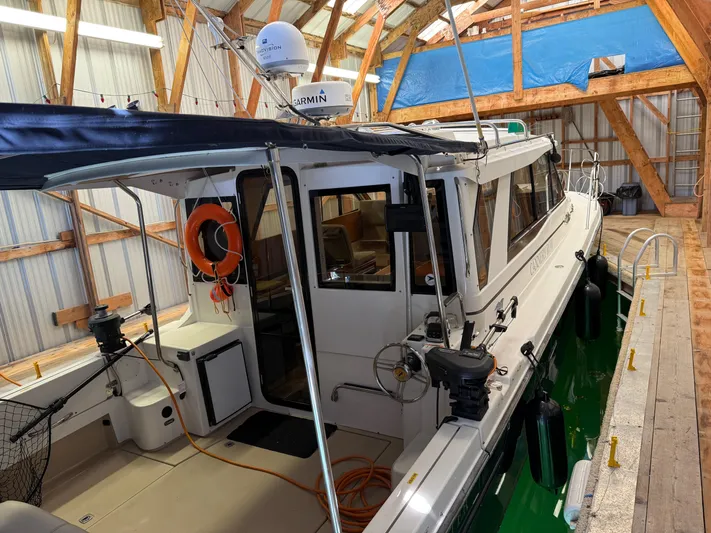 Cannery Row Yacht Photos Pics 2015 Cutwater C-30 Sedan boat docked in a wooden boathouse.