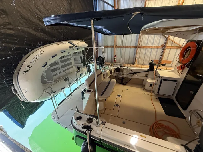 Cannery Row Yacht Photos Pics 2015 Cutwater C-30 Sedan boat interior with canopy and lifeboat in storage.