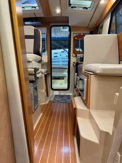 Cannery Row Yacht Photos Pics Interior of a 2015 Cutwater C-30 Sedan boat, featuring wood flooring and seating.
