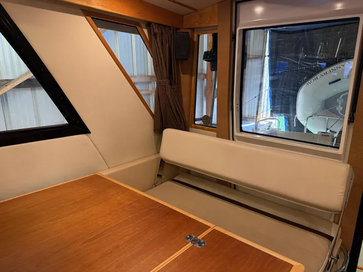 Cannery Row Yacht Photos Pics 2015 Cutwater C-30 Sedan interior with wooden table and cushioned seating.