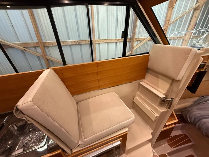 Cannery Row Yacht Photos Pics 2015 Cutwater C-30 Sedan interior with beige seating and wooden accents.