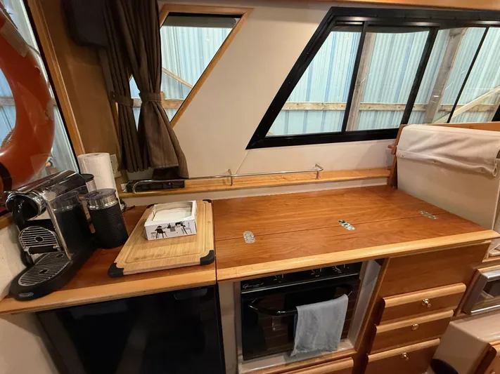 Cannery Row Yacht Photos Pics 2015 Cutwater C-30 Sedan interior with wooden countertop, coffee maker, and window view.