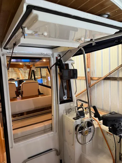 Cannery Row Yacht Photos Pics 2015 Cutwater C-30 Sedan interior with steering wheel and seating in a docked position.
