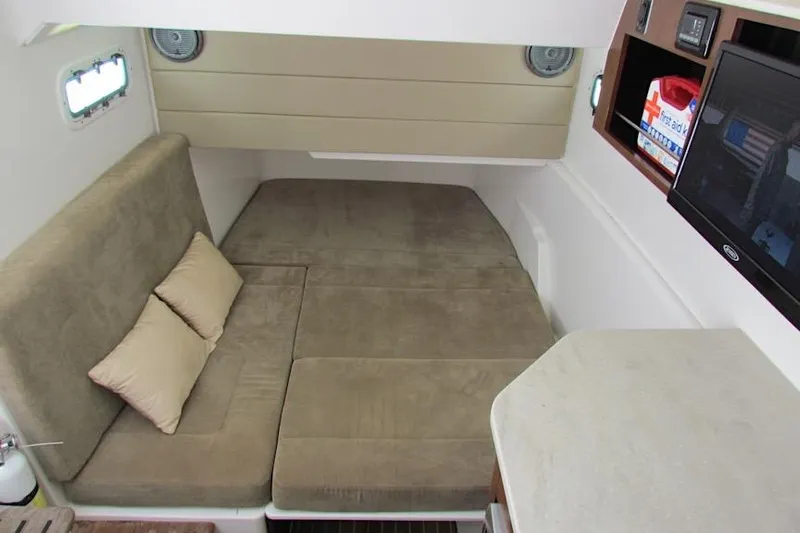  Yacht Photos Pics 2016 Everglades 435 Center Console cabin interior with beige seating and pillows.
