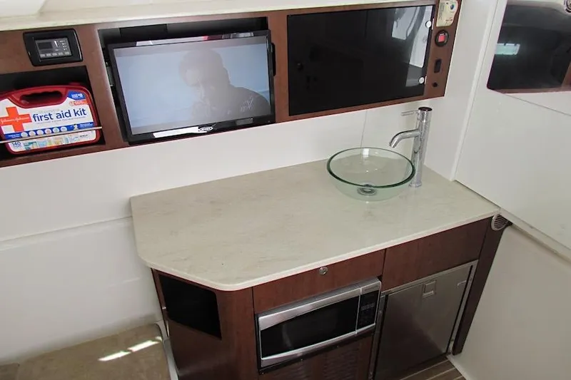  Yacht Photos Pics 2016 Everglades 435 Center Console interior with sink, TV, and first aid kit.
