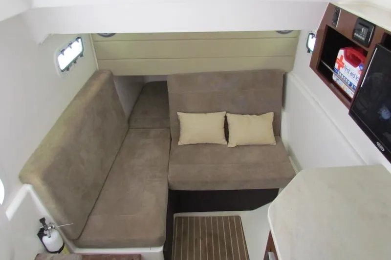 Yacht Photos Pics Interior cabin of 2016 Everglades 435 Center Console with beige seating and cushions.