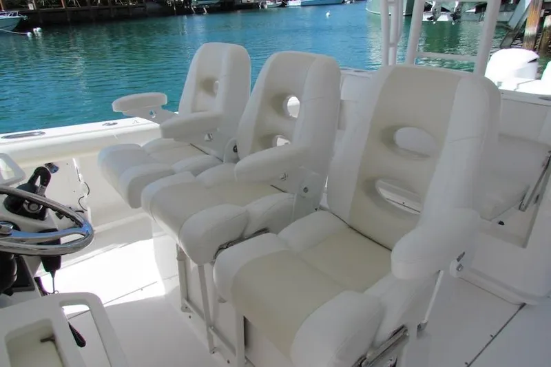  Yacht Photos Pics Luxury seating on 2016 Everglades 435 Center Console boat, featuring plush white chairs.
