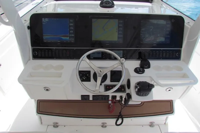  Yacht Photos Pics 2016 Everglades 435 Center Console helm with navigation screens and controls.