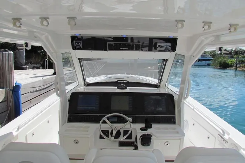  Yacht Photos Pics 2016 Everglades 435 Center Console boat cockpit with steering wheel and navigation displays.