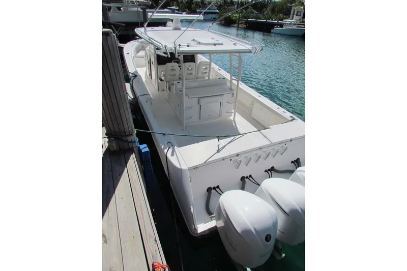  Yacht Photos Pics 2016 Everglades 435 Center Console boat docked, featuring triple outboard engines.