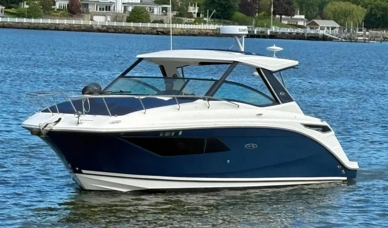  Yacht Photos Pics 2020 Sea Ray 320 Sundancer boat on calm water, featuring sleek design and modern amenities.