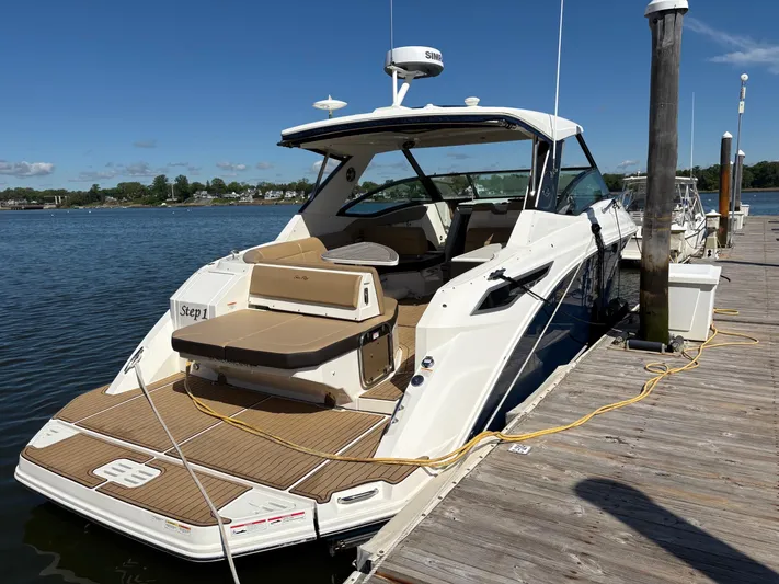  Yacht Photos Pics 2020 Sea Ray 320 Sundancer docked, showcasing sleek design and spacious deck.