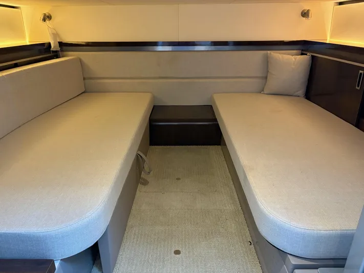  Yacht Photos Pics 2020 Sea Ray 320 Sundancer cabin interior with twin beige sofas and ambient lighting.