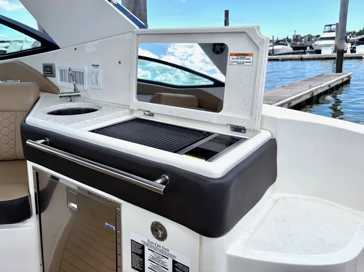  Yacht Photos Pics Sea Ray 320 Sundancer 2020 boat interior with kitchenette and marina view.