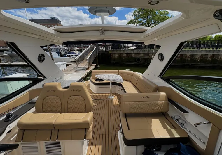  Yacht Photos Pics 2020 Sea Ray 320 Sundancer boat interior with tan seating and open sunroof.
