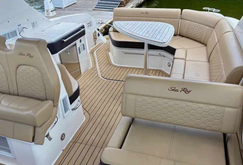  Yacht Photos Pics 2020 Sea Ray 320 Sundancer boat interior with beige seating and wooden deck.