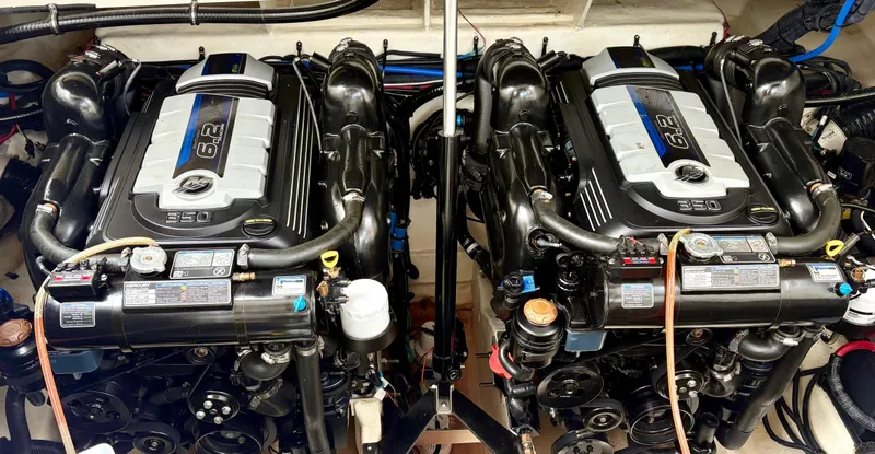  Yacht Photos Pics Twin engines of a 2020 Sea Ray 320 Sundancer boat, showcasing detailed mechanics.