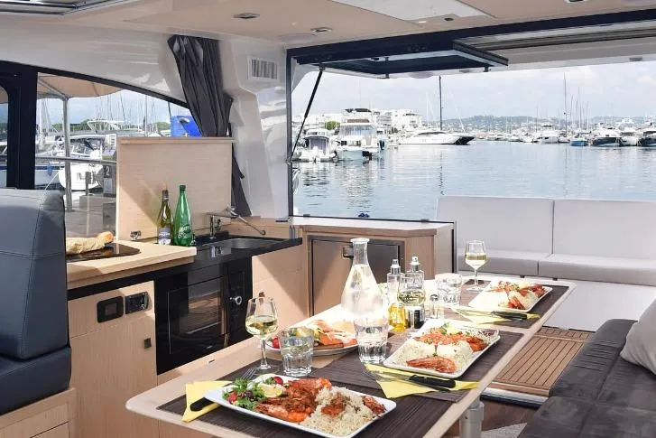  Yacht Photos Pics Interior of 2024 Parker Poland 110 Monaco yacht with dining setup and marina view.