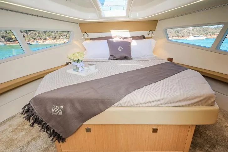  Yacht Photos Pics Luxurious interior of 2024 Parker Poland 110 Monaco yacht with elegant bedding and scenic views.