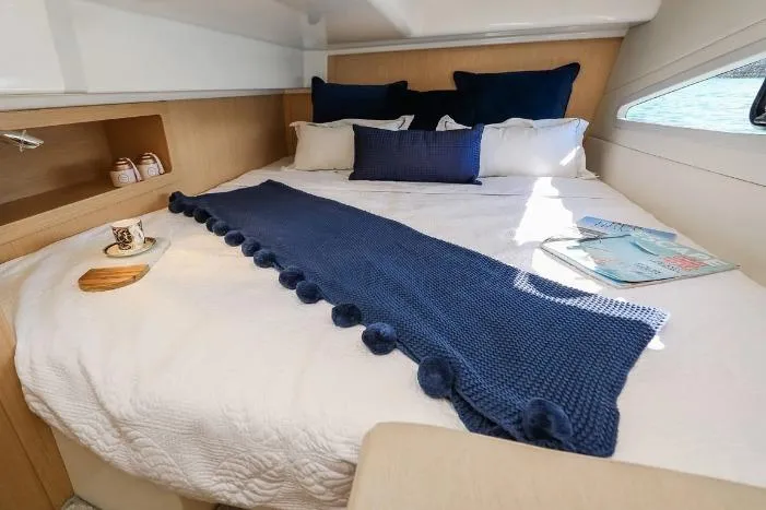  Yacht Photos Pics Luxurious cabin interior of 2024 Parker Poland 110 Monaco with cozy bedding and elegant decor.