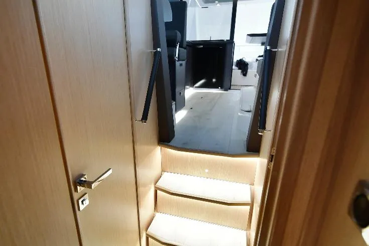  Yacht Photos Pics Interior view of 2024 Parker Poland 110 Monaco yacht with modern wooden stairs.