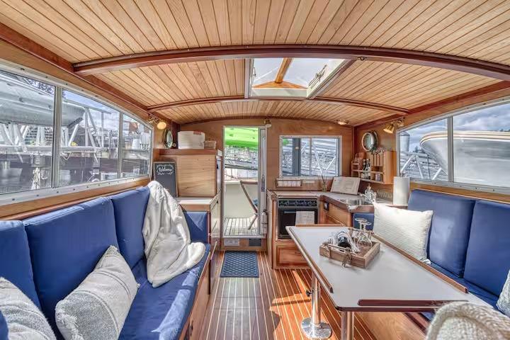Interior of 1996 Devlin 38 boat with wooden finish and blue seating.