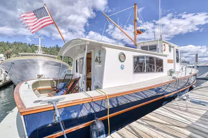 Classic 1996 Devlin 38 boat docked, featuring American flag and scenic marina backdrop.