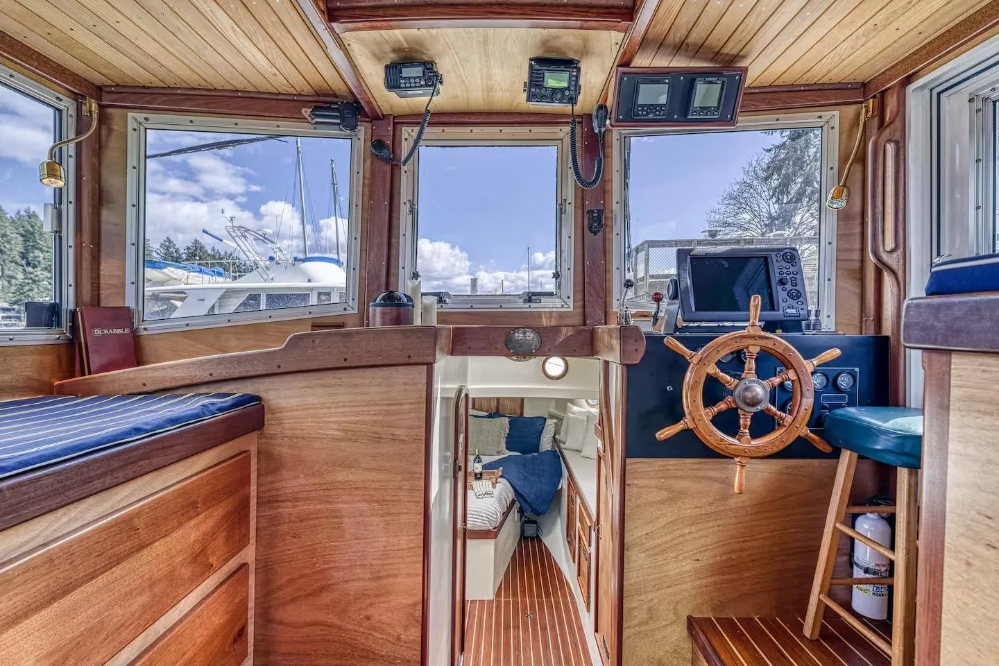 Interior of a 1996 Devlin 38 boat with wooden helm and navigation equipment.