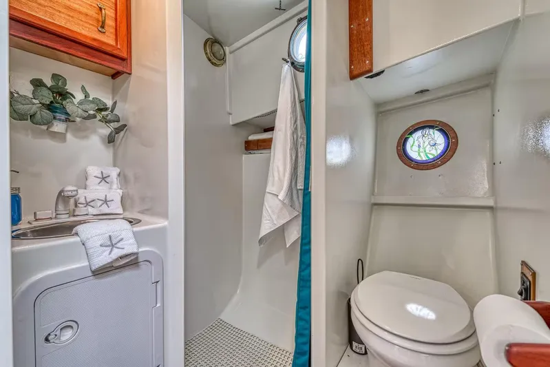  Yacht Photos Pics Compact 1996 Devlin 38 boat bathroom with sink, toilet, porthole, and nautical decor.