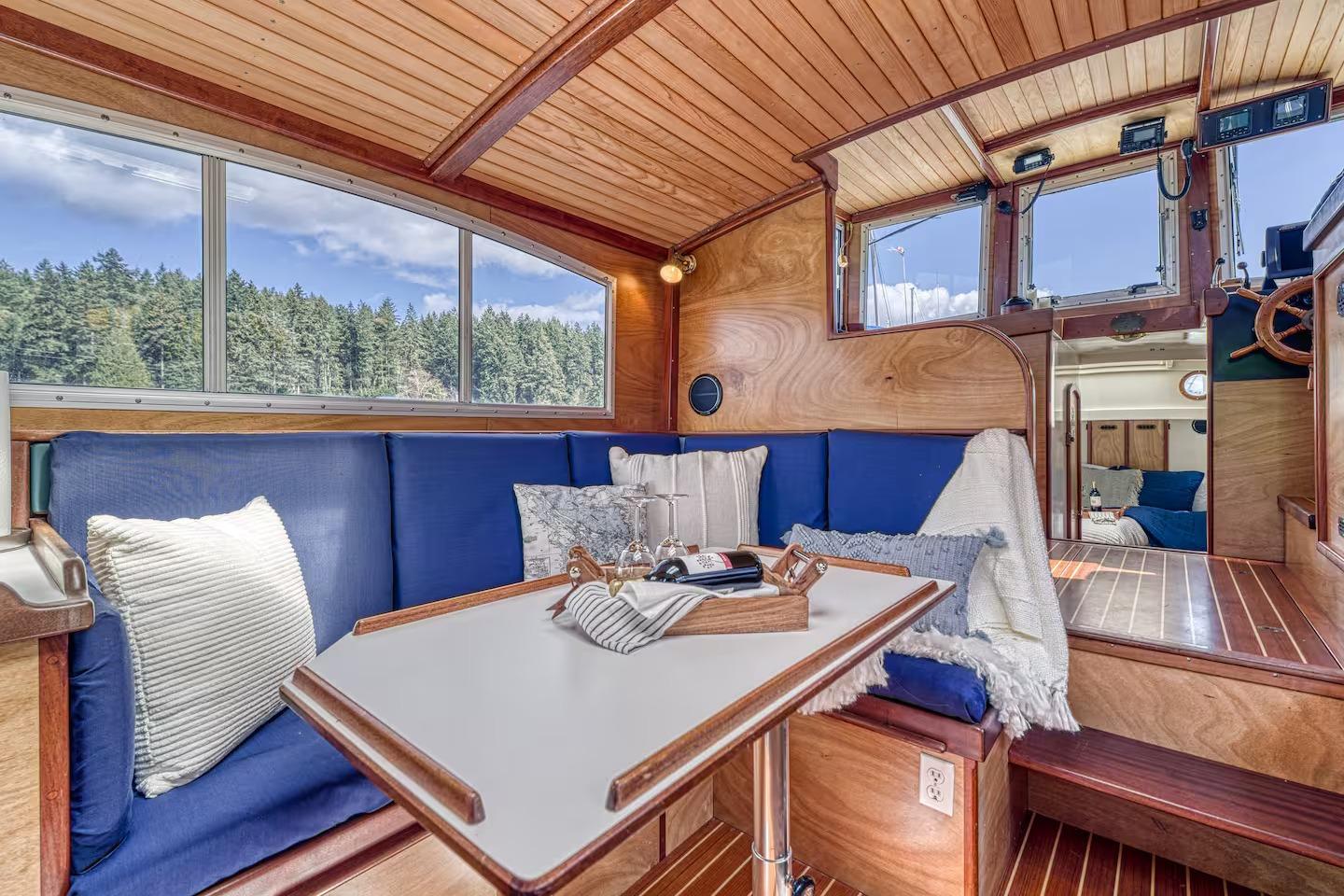 Interior of 1996 Devlin 38 boat with cozy seating and wooden finishes.