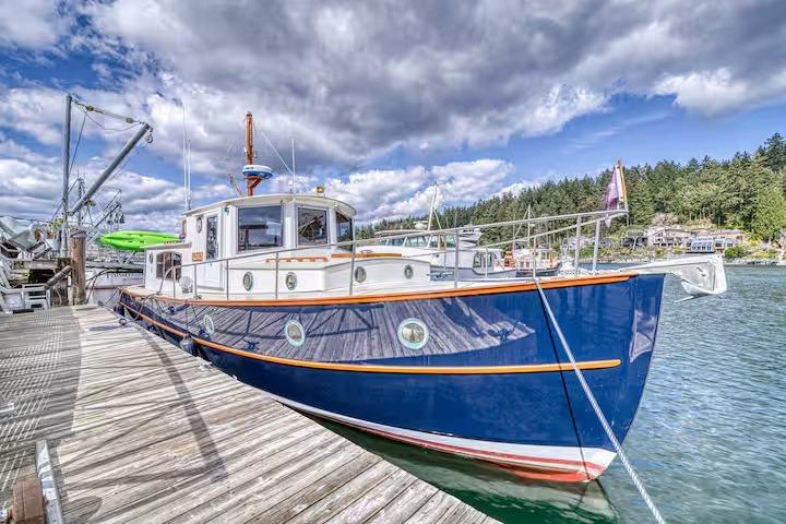 Classic 1996 Devlin 38 boat docked under cloudy sky, surrounded by scenic greenery.