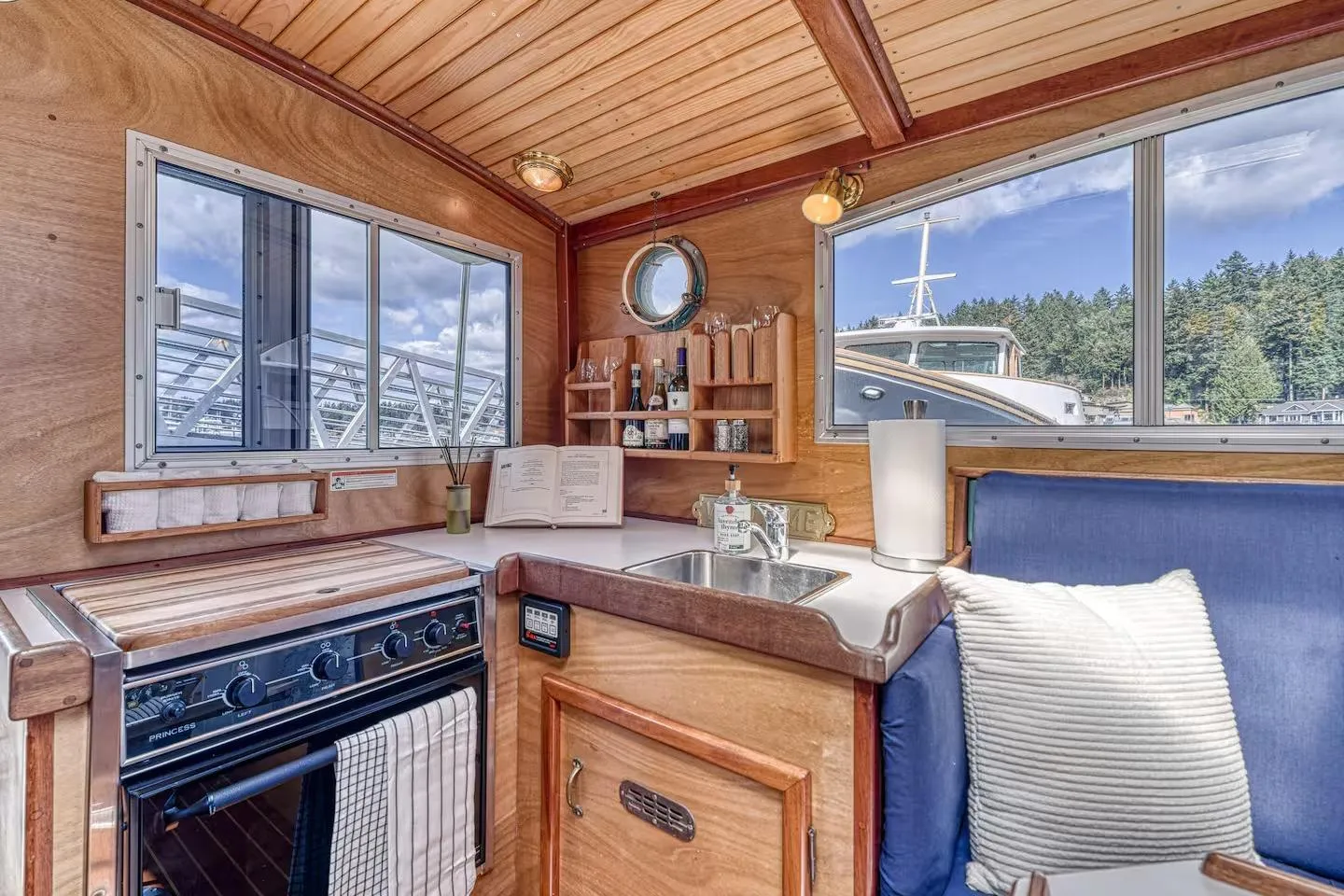 Cozy 1996 Devlin 38 boat interior with kitchen, stove, and scenic window views.