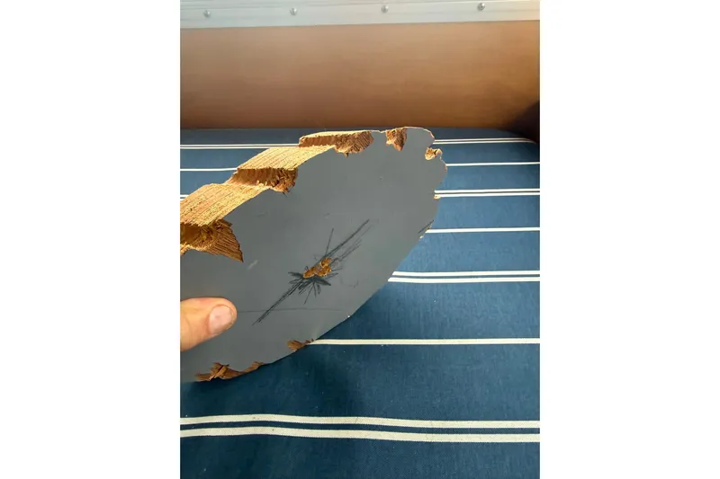  Yacht Photos Pics Damaged wooden piece from a 1996 Devlin 38 boat, showing cracks and splinters.