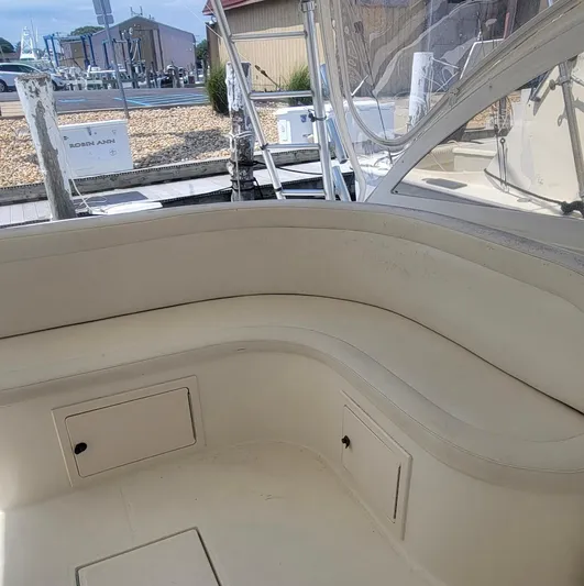 Robin Ann Yacht Photos Pics 2004 Carolina Classic 35 Express boat interior with beige seating and storage compartments.
