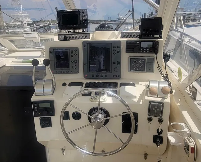 Robin Ann Yacht Photos Pics 2004 Carolina Classic 35 Express boat helm with navigation equipment and steering wheel.